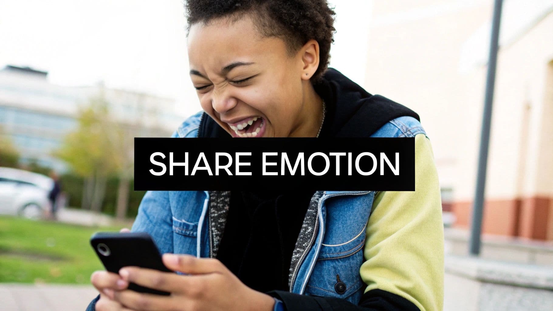 A person laughing intensely while looking at a smartphone, with 'SHARE EMOTION' text.